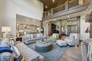 Living room featuring dark wood-type flooring and a high ceiling