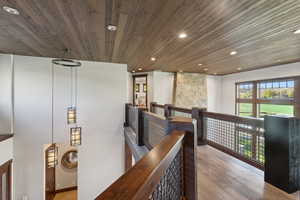 Hallway featuring wood ceiling and light hardwood / wood-style flooring