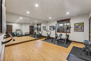 Workout area featuring hardwood / wood-style flooring