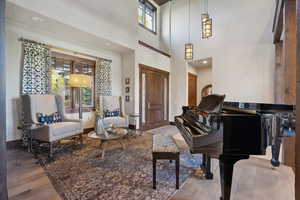 Interior space with a high ceiling and hardwood / wood-style flooring