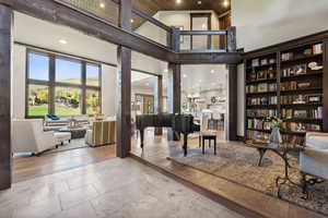 Living area featuring light hardwood / wood-style floors and high vaulted ceiling