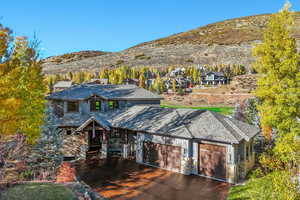 View of front of house featuring a mountain view and a garage