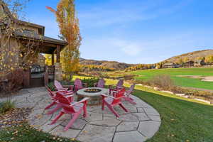 View of patio featuring a mountain view and an outdoor fire pit