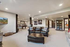 Carpeted living room with billiards