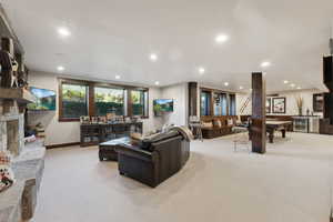 Living room with light carpet, beverage cooler, and pool table