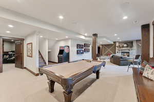 Game room with light carpet, a fireplace, and billiards