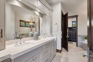 Bathroom with a wealth of natural light and vanity