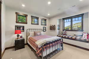 Bedroom featuring light colored carpet