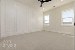 Unfurnished room with ceiling fan and light colored carpet