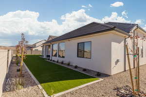 View of side of property featuring a yard