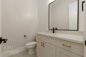 Bathroom with tile patterned flooring, vanity, and toilet