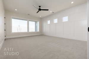 Carpeted empty room with ceiling fan