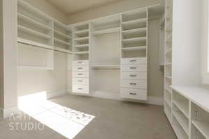 Spacious closet with light colored carpet