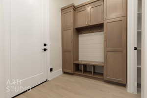 Mudroom with light hardwood / wood-style floors