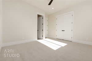 Unfurnished bedroom featuring ceiling fan, light carpet, and a closet