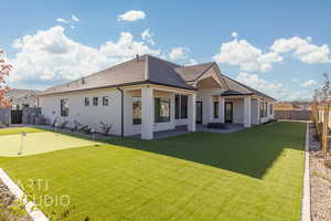 Rear view of house with a yard and central air condition unit