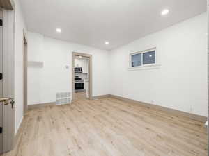 Unfurnished room with light hardwood / wood-style floors