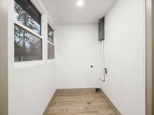 Laundry area with light hardwood / wood-style floors and washer hookup