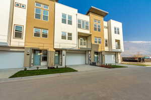 Multi unit property featuring a mountain view, a garage, and central air condition unit