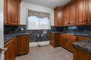 Laundry room with full built in cabinents and countertops.