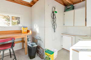 Exterior shed with sink, hot and cold water, and work bench.