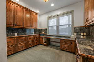 Main floor office with full built in Cabinetry and desks.