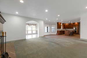 Unfurnished living room with light colored carpet