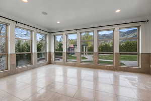 Interior space featuring tile patterned floors, a mountain view, and recessed lighting