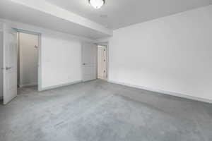 Unfurnished bedroom with carpet floors and baseboards