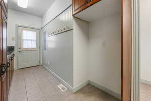 Mudroom Doorway with full cabinetry on all sides. Cabinent grade coat hooks, lockers, and a cut out for an additional fridge or freezer.