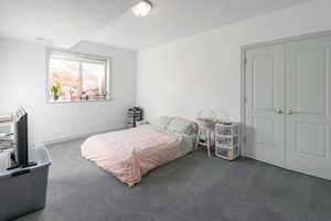 Basement Bedroom featuring dark carpet and a closet