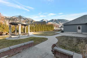 View of yard with a gazebo, a mountain view, and a patio area