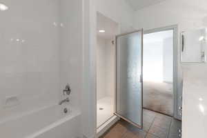 Bathroom with tile patterned floors and plus walk in shower