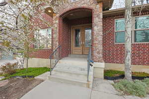 Doorway to property with french doors and brick siding