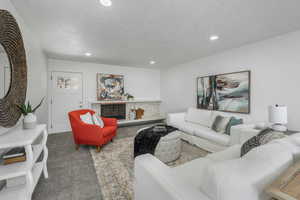 Living room with carpet floors and a textured ceiling