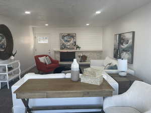 Carpeted living room featuring a textured ceiling