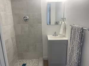 Bathroom with vanity and a tile shower