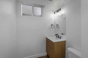 Bathroom with vanity, hardwood / wood-style flooring, and toilet