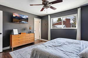 Bedroom with ceiling fan and dark hardwood / wood-style floors