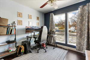 Office space with ceiling fan and wood-type flooring