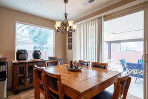 Dining room featuring light hardwood / wood-style floors and a chandelier