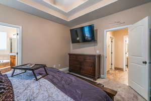 Bedroom featuring carpet and ensuite bath