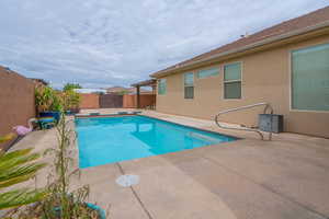 View of swimming pool with a patio area