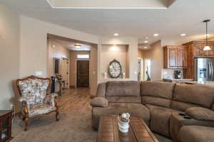 Living room with carpet flooring and a textured ceiling