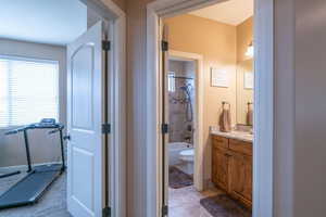 Full bathroom featuring tile patterned floors, vanity, toilet, and tiled shower / bath