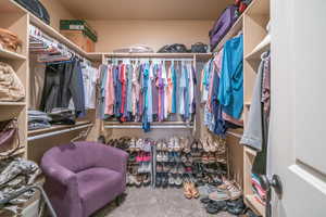 Spacious closet with carpet floors