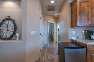 Corridor with hardwood / wood-style flooring