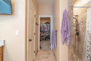 Bathroom featuring curtained shower and vanity