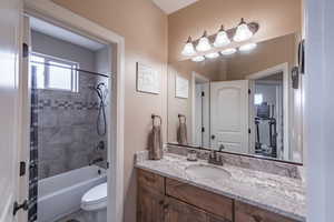 Full bathroom featuring vanity, toilet, and tiled shower / bath