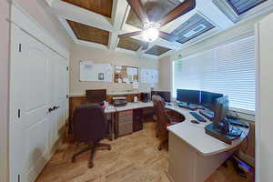 Home office with beamed ceiling, ceiling fan, and coffered ceiling